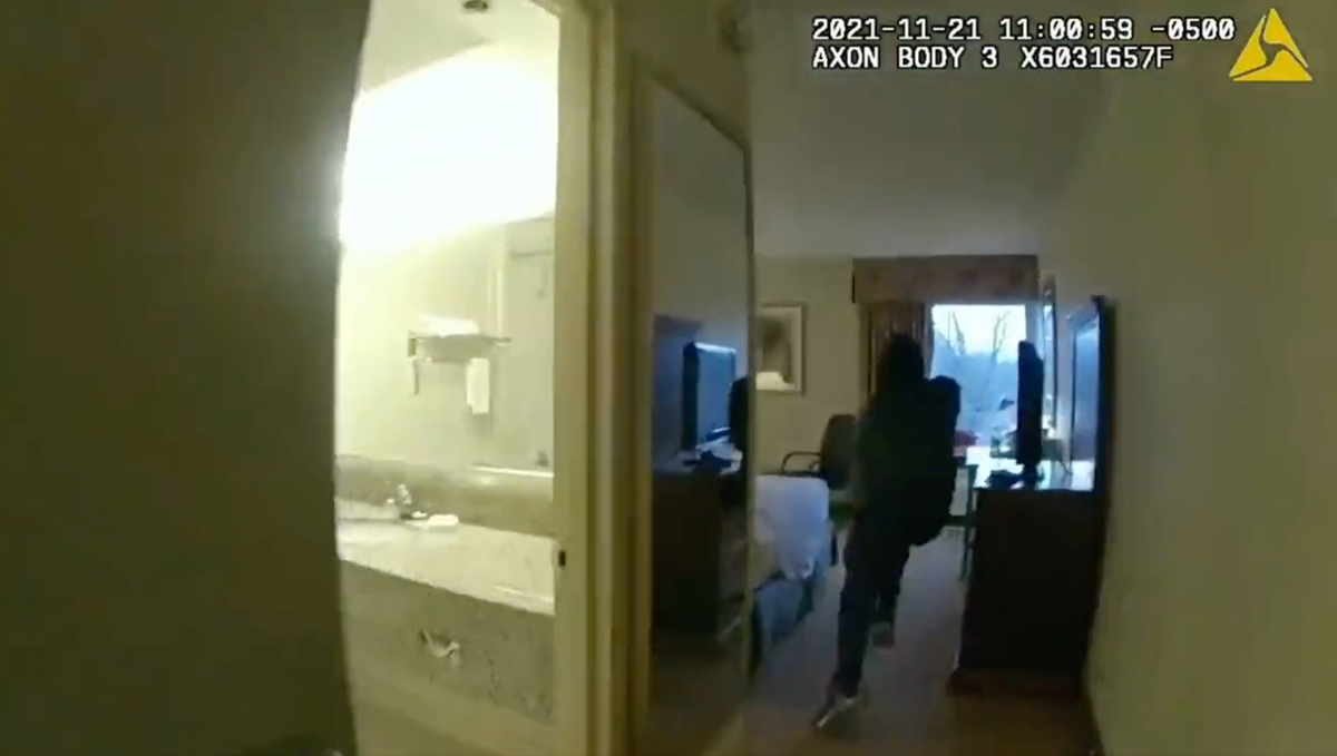 Police video shows moment suspect tries to jump out window but bounces off glass The Independent